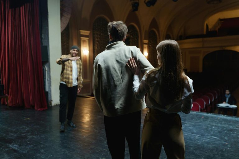 Actors in rehearsal on stage, capturing the art and emotion of theater.