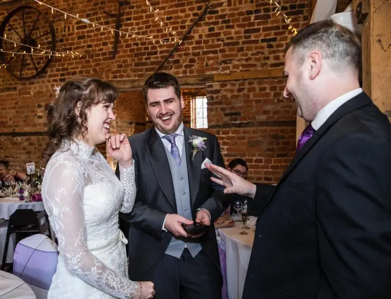 Wedding magician performing close-up magic for bride and groom
