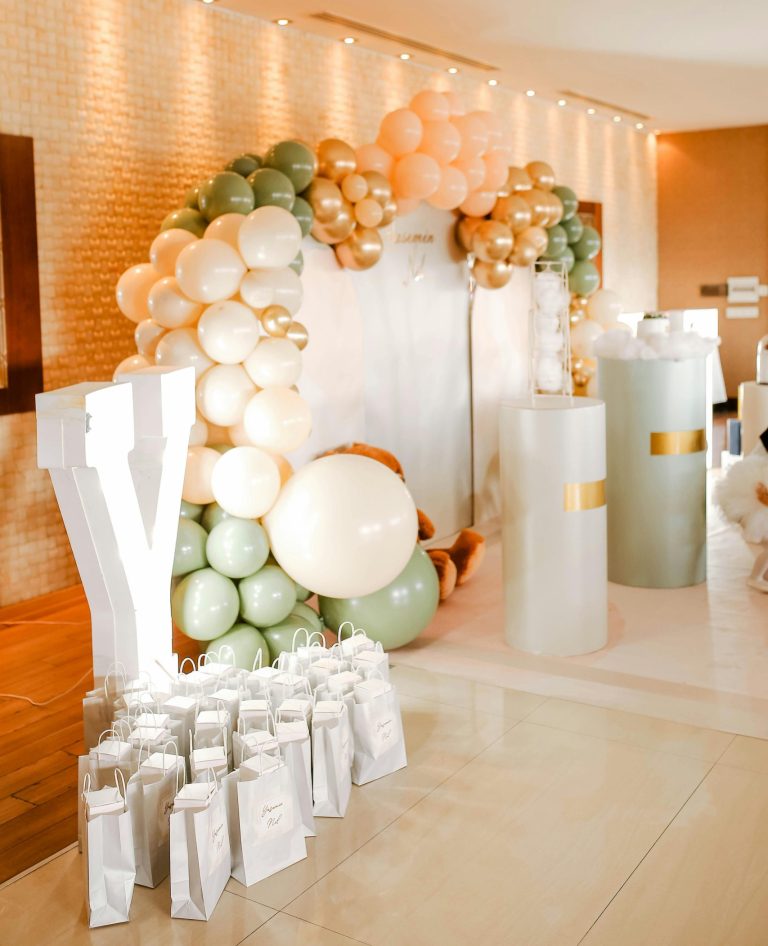 Stylish balloon arch with gift bags perfect for parties and celebrations.